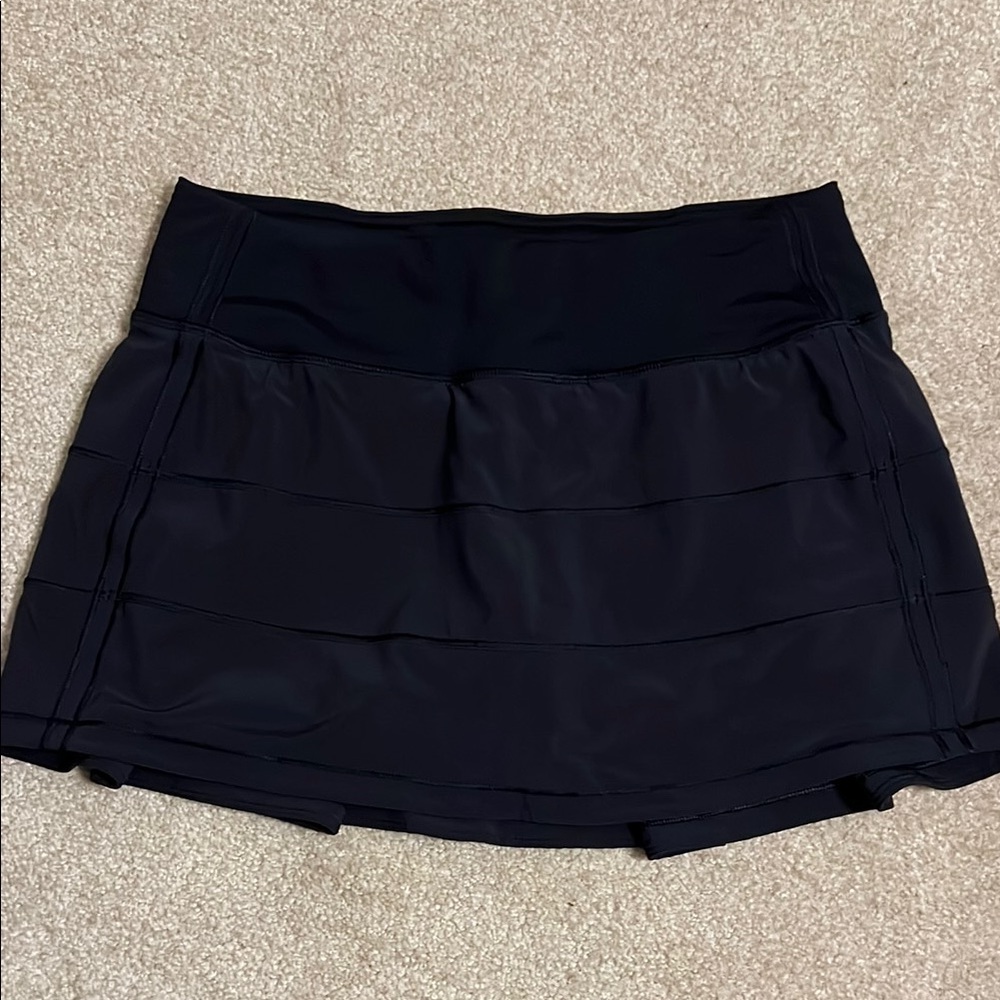 Lululemon Black tennis skirt with pleats in the back. Size 4   Never been worn
